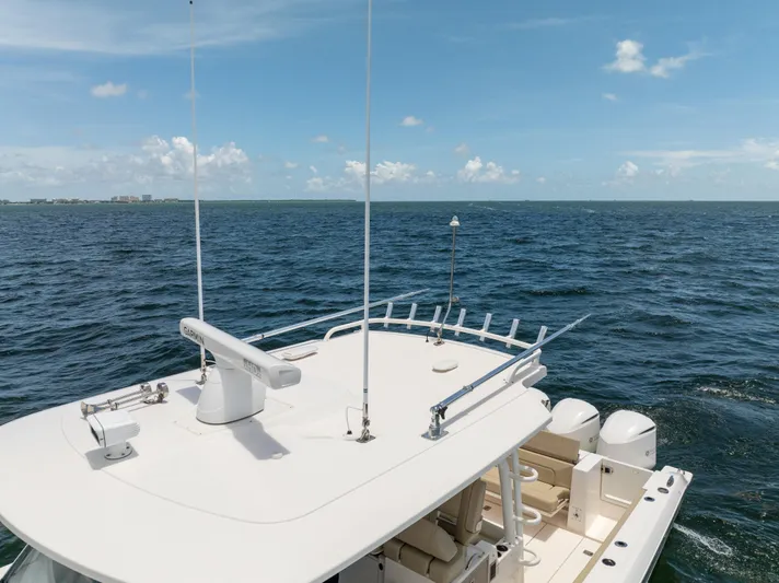 100 Percent Yacht Photos Pics 2018 Pursuit S 368 Sport boat on open sea under clear blue sky.