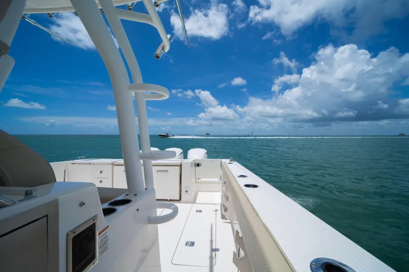 100 Percent Yacht Photos Pics 2018 Pursuit S 368 Sport boat on open water under a clear blue sky.