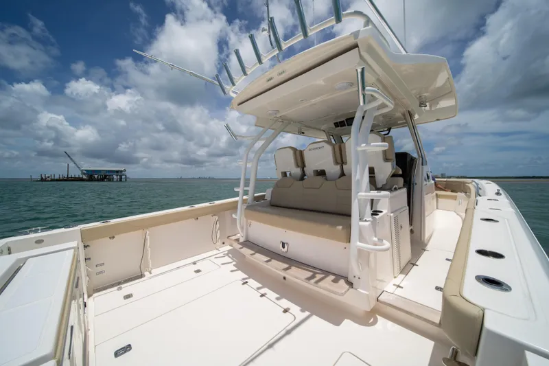 100 Percent Yacht Photos Pics 2018 Pursuit S 368 Sport boat on open water under a cloudy sky.