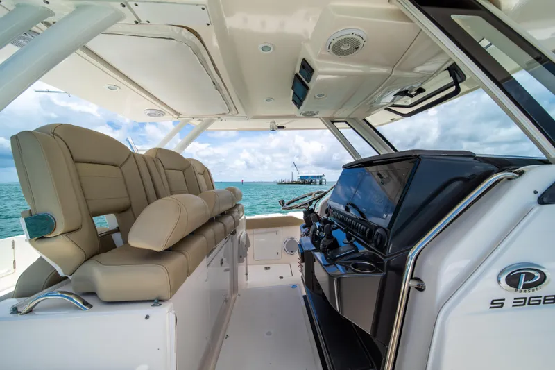 100 Percent Yacht Photos Pics 2018 Pursuit S 368 Sport boat interior with beige seating and modern dashboard.
