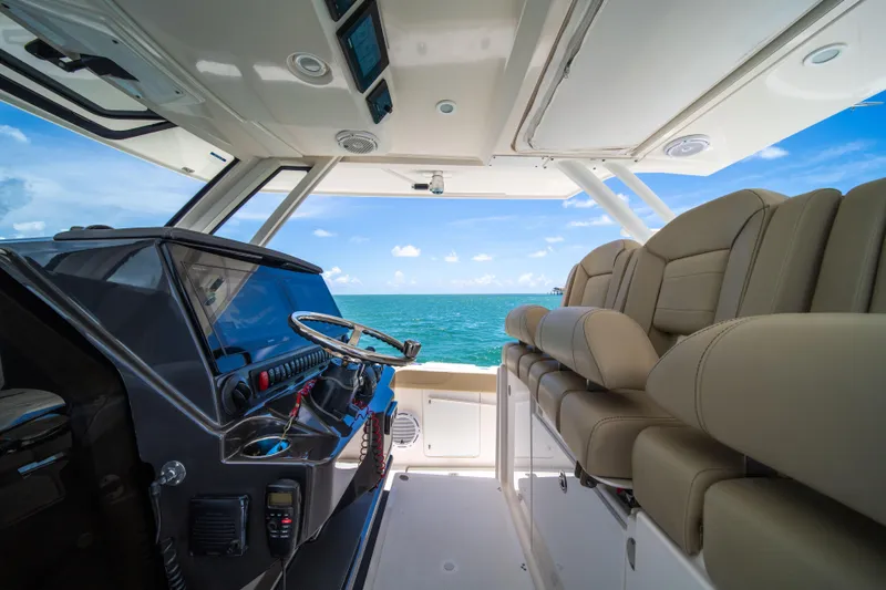 100 Percent Yacht Photos Pics Interior view of 2018 Pursuit S 368 Sport boat with ocean backdrop.