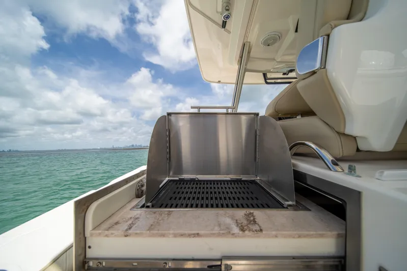 100 Percent Yacht Photos Pics Outdoor grill on 2018 Pursuit S 368 Sport boat with ocean view.