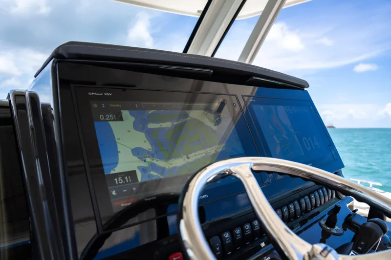 100 Percent Yacht Photos Pics Helm of 2018 Pursuit S 368 Sport boat with navigation screens and steering wheel.