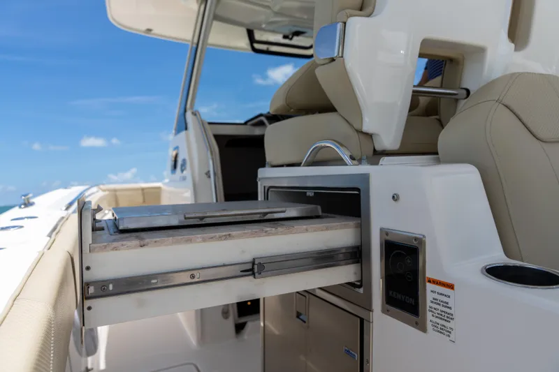 100 Percent Yacht Photos Pics 2018 Pursuit S 368 Sport boat interior with open storage compartment and seating.