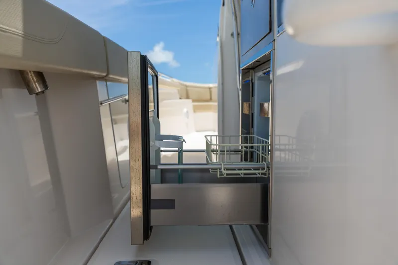 100 Percent Yacht Photos Pics 2018 Pursuit S 368 Sport boat with open storage compartment, showcasing sleek design.