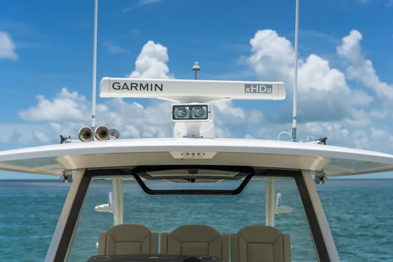 100 Percent Yacht Photos Pics 2018 Pursuit S 368 Sport boat with Garmin xHD2 radar, ocean backdrop.