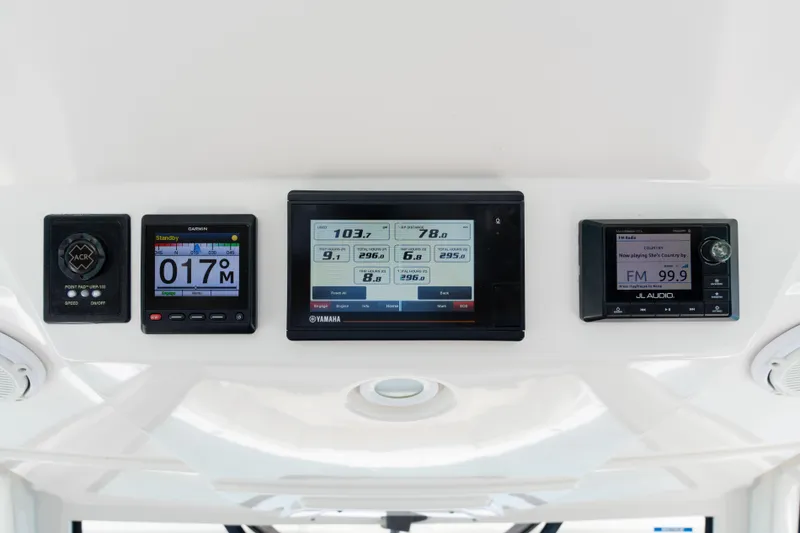 100 Percent Yacht Photos Pics Dashboard of a 2018 Pursuit S 368 Sport boat with navigation and control displays.