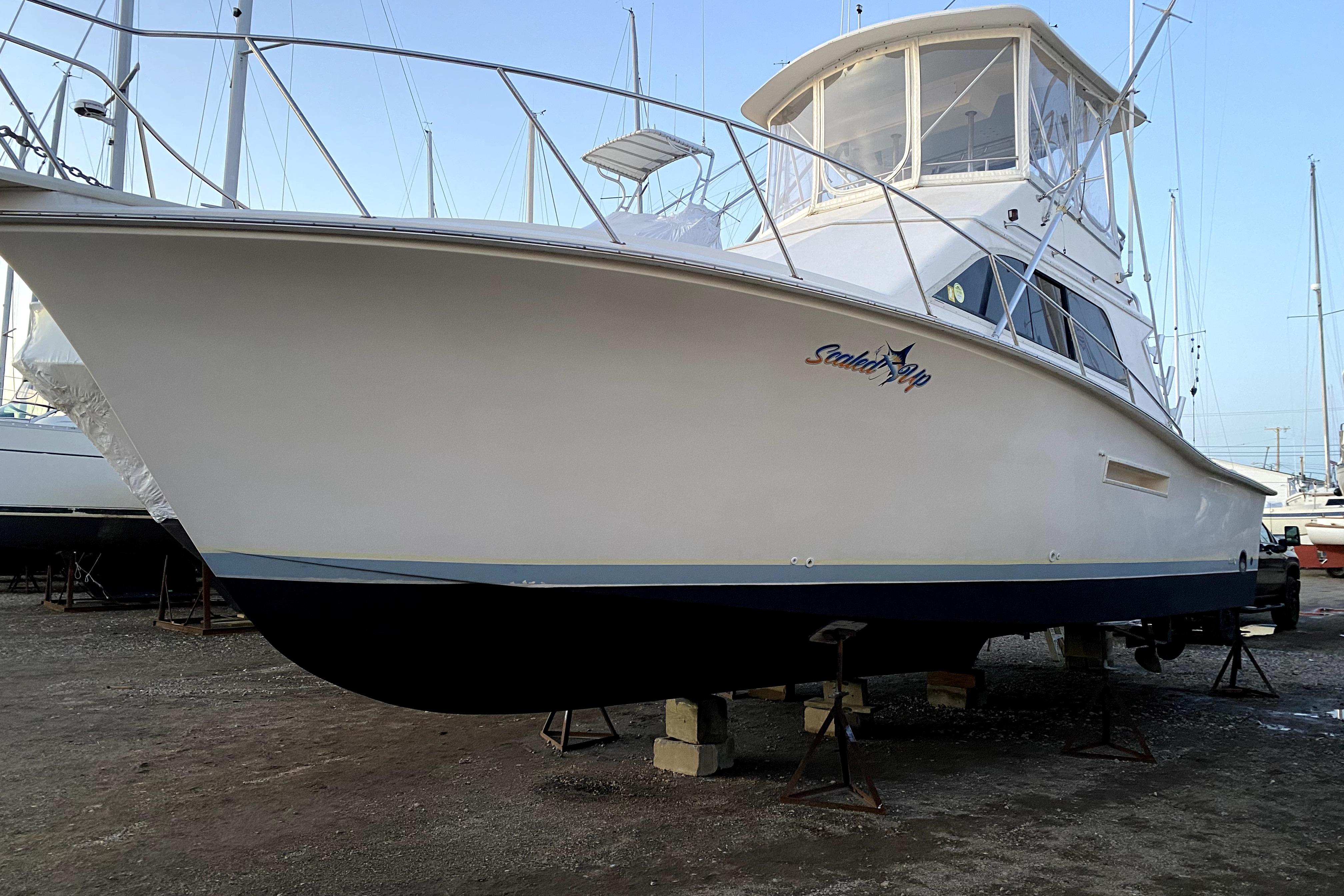 1991 Pacemaker 37 Sportfisherman boat on dry dock, side view.