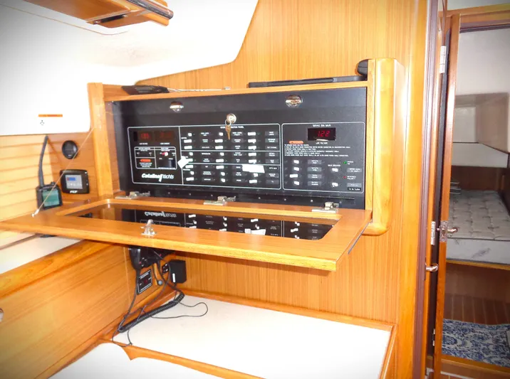 Meru Yacht Photos Pics 2019 Catalina 425 yacht interior with control panel and wooden cabinetry.