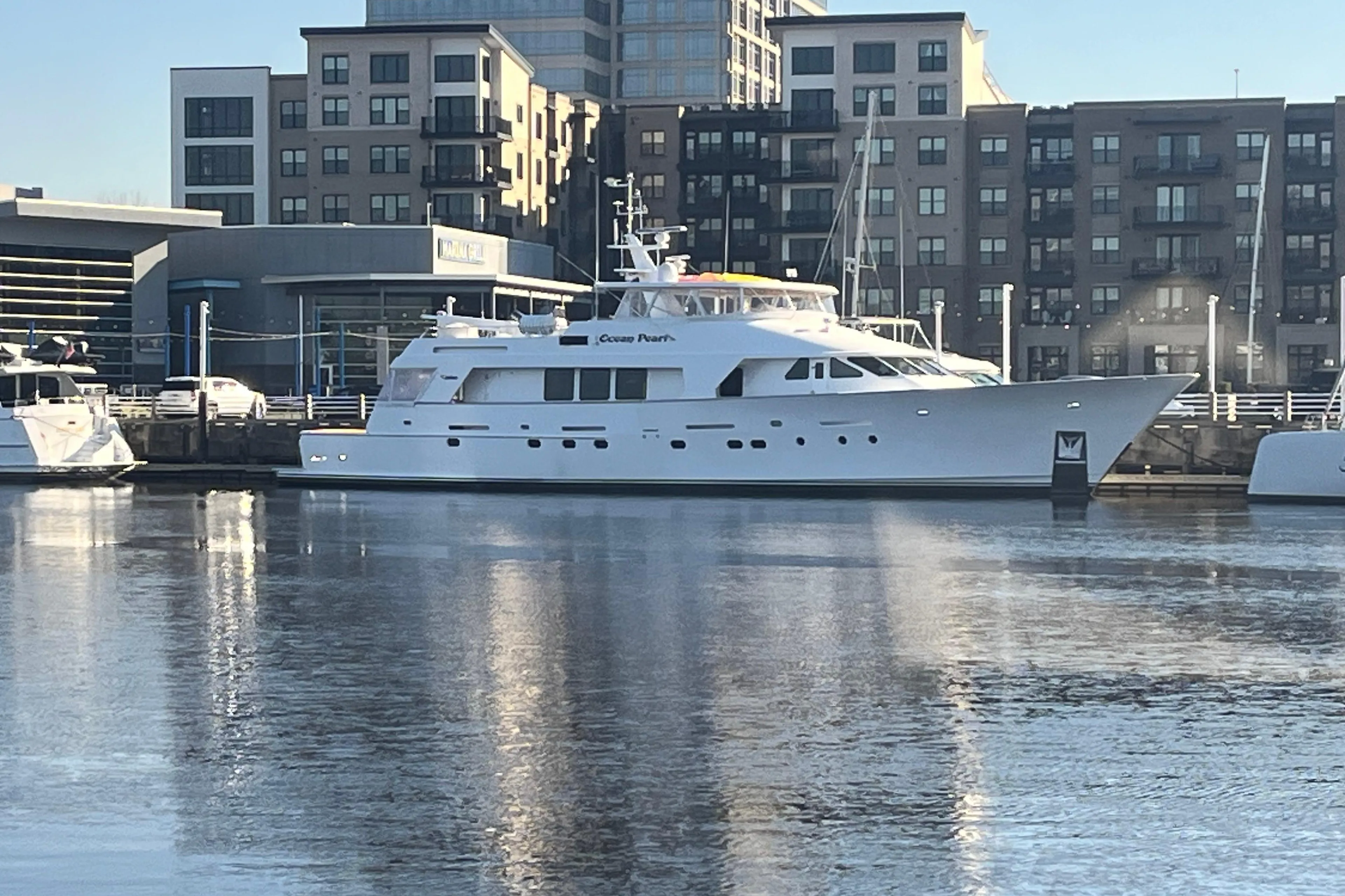 Luxury 1988 Christensen Custom yacht docked in urban marina setting.