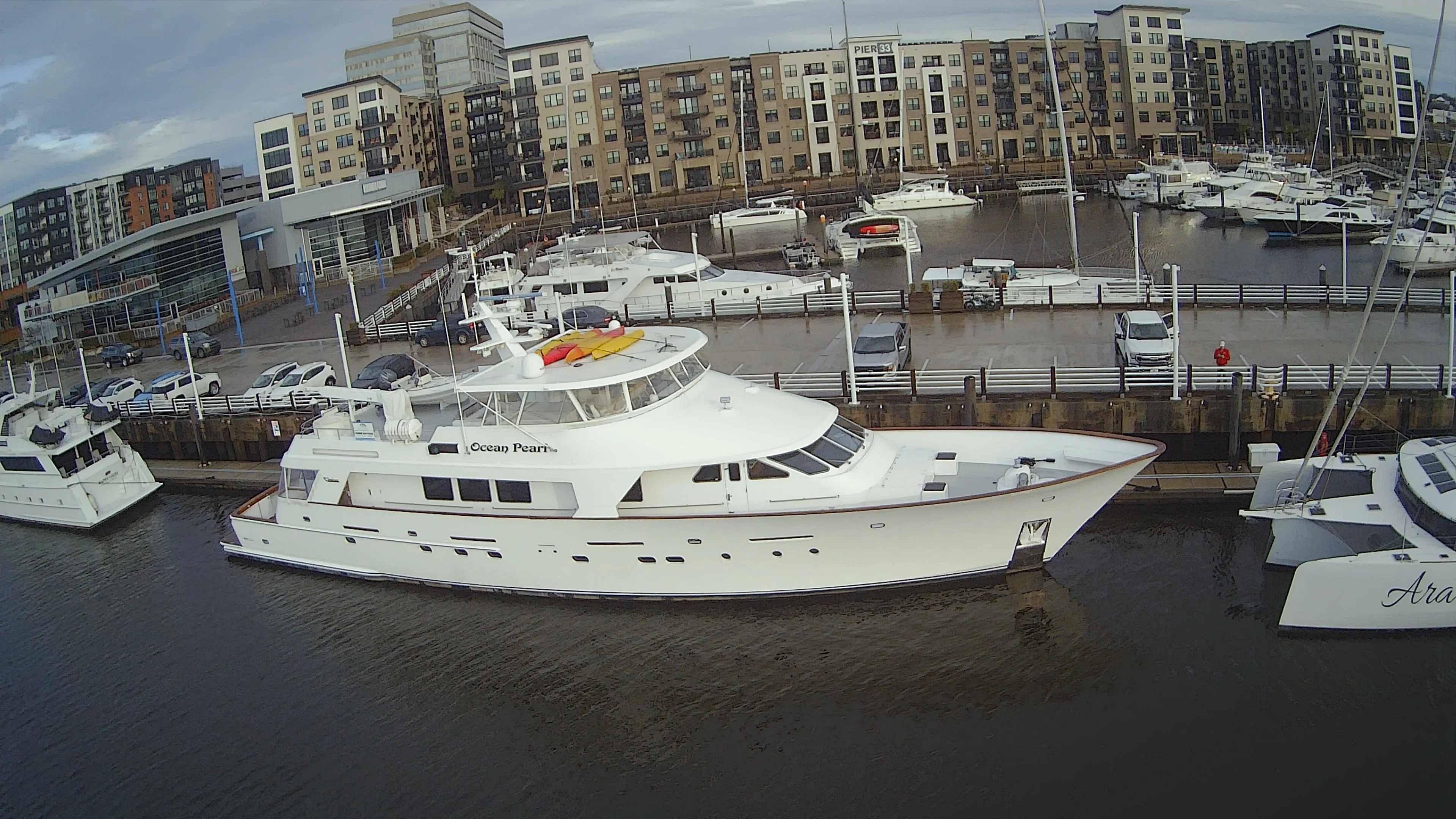 1988 Christensen Custom yacht docked in marina, surrounded by buildings.