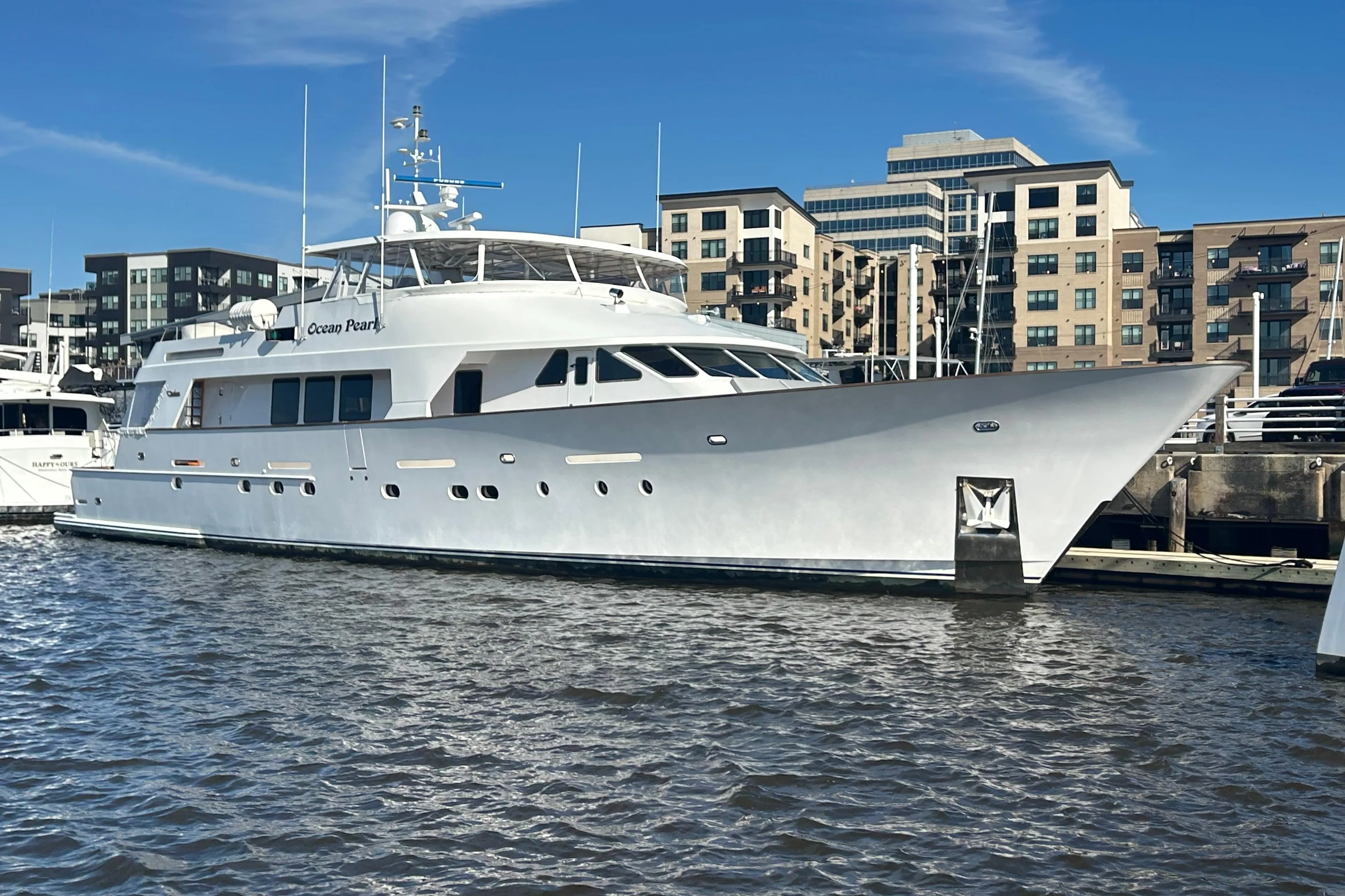 Luxury 1988 Christensen Custom yacht docked in urban marina setting.