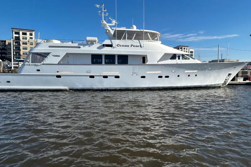 Ocean Pearl Yacht Photos Pics Luxury 1988 Christensen Custom yacht "Ocean Pearl" docked in marina under clear blue sky.