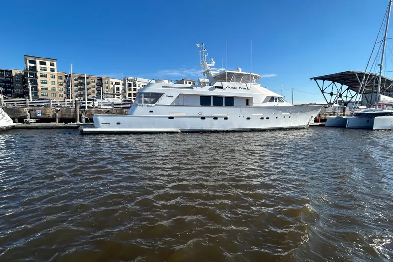 Ocean Pearl Yacht Photos Pics Luxury Christensen Custom yacht docked in marina, 1988 model, with urban backdrop.