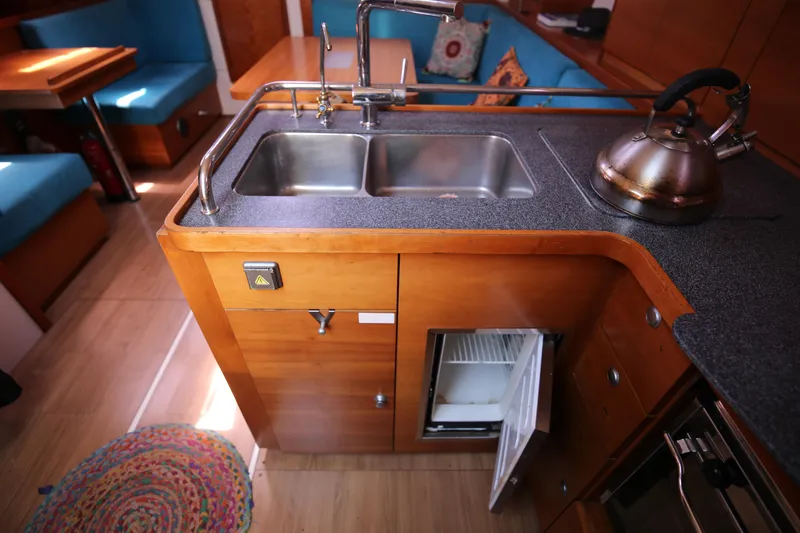  Yacht Photos Pics Interior of 2007 Hanse 430e yacht kitchen with sink, fridge, and kettle.