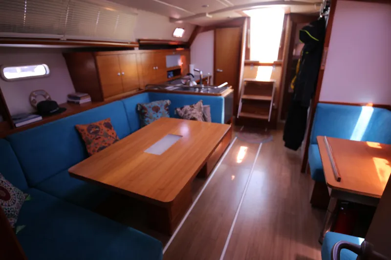  Yacht Photos Pics Interior of 2007 Hanse 430e yacht with blue seating and wooden table.