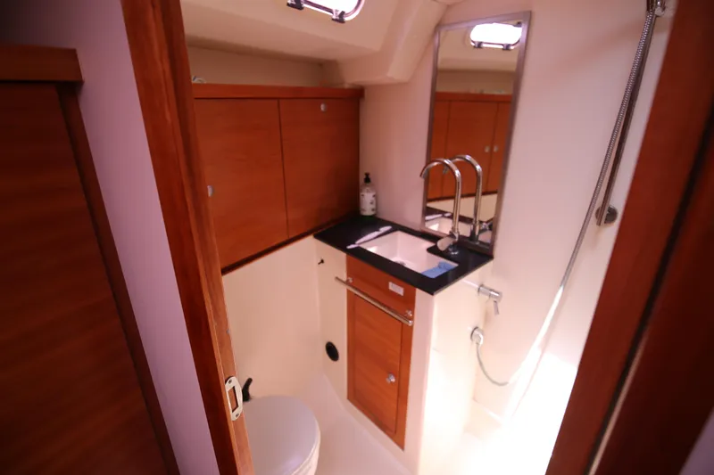  Yacht Photos Pics Bathroom interior of 2007 Hanse 430e yacht with wooden cabinets and modern fixtures.