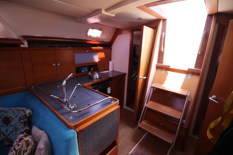  Yacht Photos Pics Interior of 2007 Hanse 430e yacht, featuring a compact kitchen and wooden cabinetry.