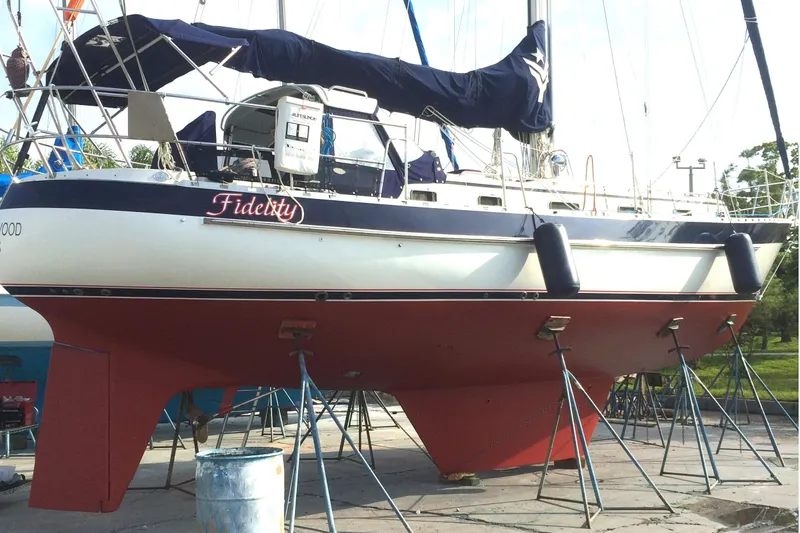 Fidelity Yacht Photos Pics Valiant 42 CE/SE 2010 sailboat on stands, named "Fidelity," with red hull and blue cover.