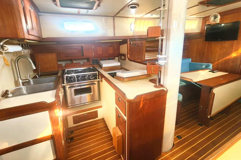 Fidelity Yacht Photos Pics Interior of 2010 Valiant 42 CE/SE yacht with wooden cabinetry and modern amenities.