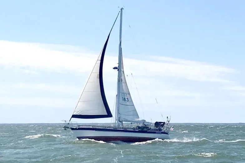 Fidelity Yacht Photos Pics Sailing yacht Valiant 42 CE/SE 2010 navigating ocean waves under clear skies.