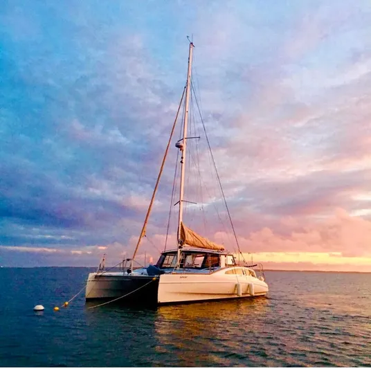 Surfer Girl Yacht Photos Pics 2018 Maine Cat 38 LS catamaran at sunset on calm waters.