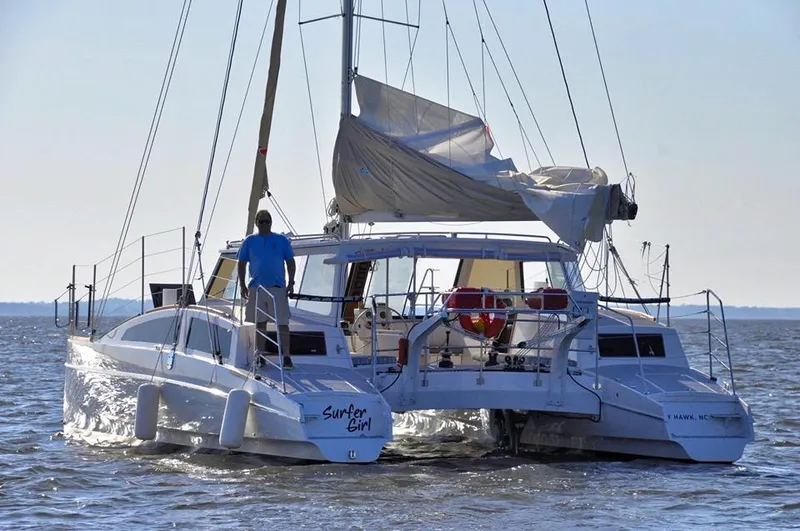 Surfer Girl Yacht Photos Pics 2018 Maine Cat 38 LS catamaran sailing on open water, rear view.