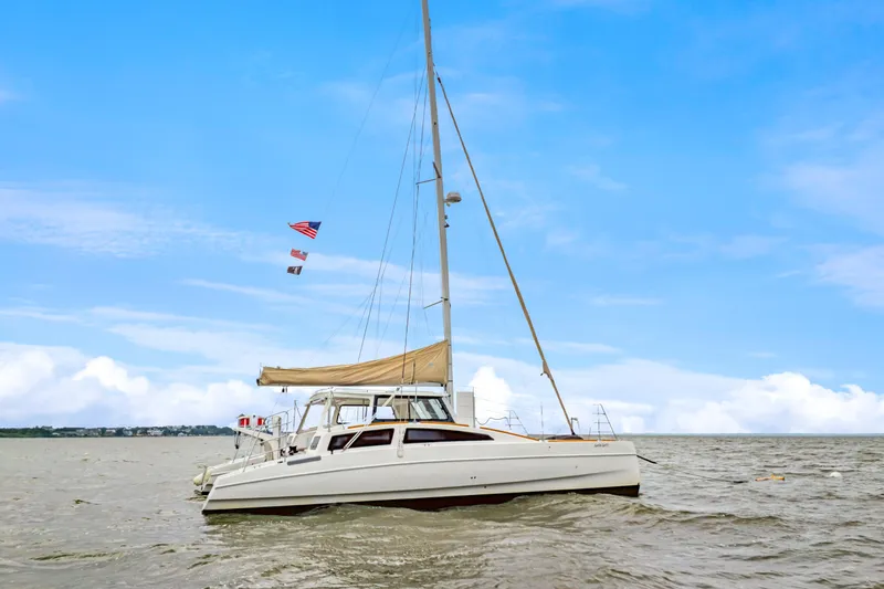 Surfer Girl Yacht Photos Pics 2018 Maine Cat 38 LS sailing on open water under a clear blue sky.