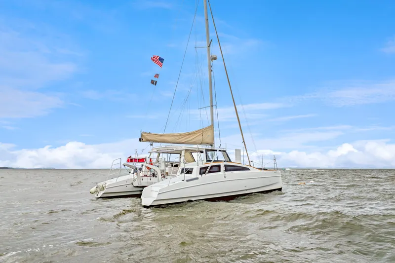 Surfer Girl Yacht Photos Pics 2018 Maine Cat 38 LS catamaran sailing on open water under a clear blue sky.