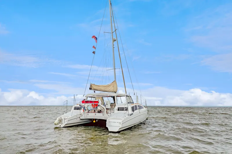 Surfer Girl Yacht Photos Pics 2018 Maine Cat 38 LS catamaran sailing on open water under a clear blue sky.