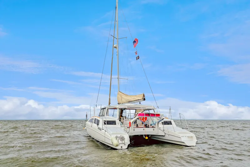 Surfer Girl Yacht Photos Pics 2018 Maine Cat 38 LS catamaran sailing on open water under a clear blue sky.