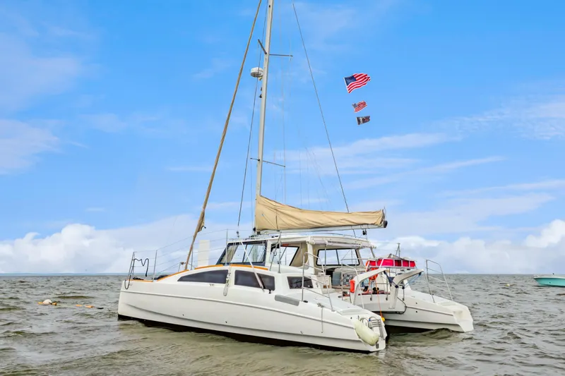 Surfer Girl Yacht Photos Pics 2018 Maine Cat 38 LS catamaran sailing on calm waters under a clear blue sky.