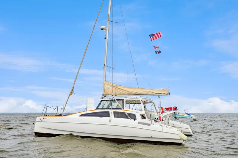 Surfer Girl Yacht Photos Pics 2018 Maine Cat 38 LS catamaran sailing on open water under a clear blue sky.