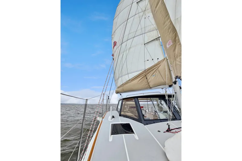 Surfer Girl Yacht Photos Pics 2018 Maine Cat 38 LS sailing on open water under clear blue skies.