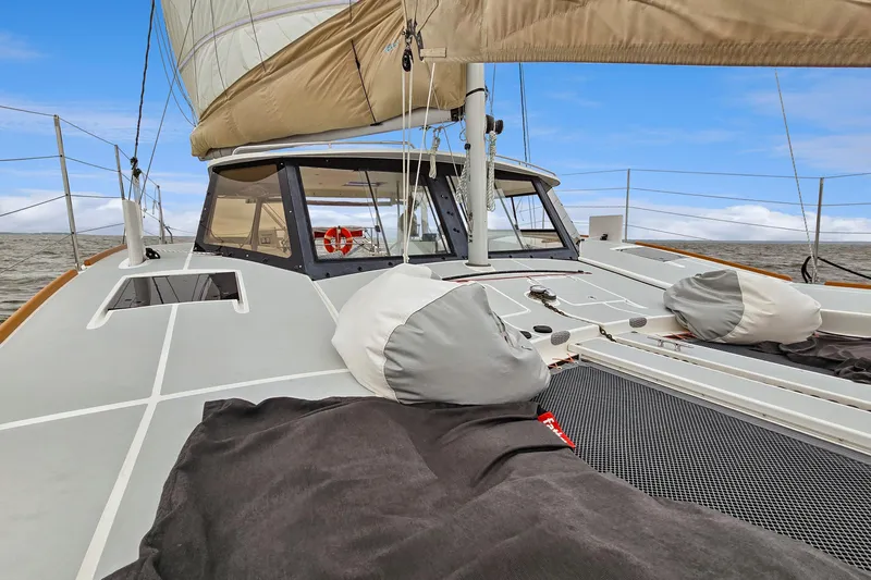 Surfer Girl Yacht Photos Pics 2018 Maine Cat 38 LS sailboat deck with sails, ocean view, and clear sky.