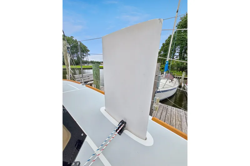 Surfer Girl Yacht Photos Pics 2018 Maine Cat 38 LS sailboat deck with centerboard and rigging, docked near trees.