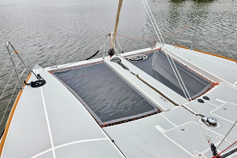 Surfer Girl Yacht Photos Pics 2018 Maine Cat 38 LS catamaran deck with netting, ropes, and water view.