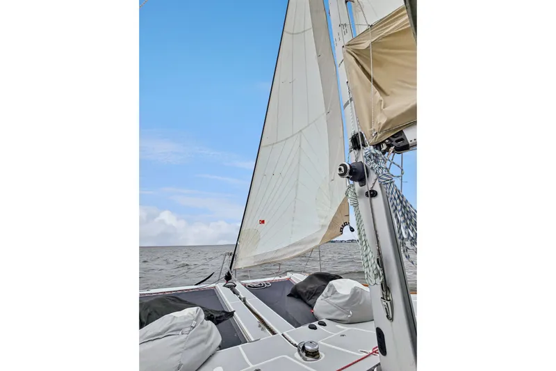 Surfer Girl Yacht Photos Pics Sailing on a 2018 Maine Cat 38 LS catamaran with white sails against a blue sky.