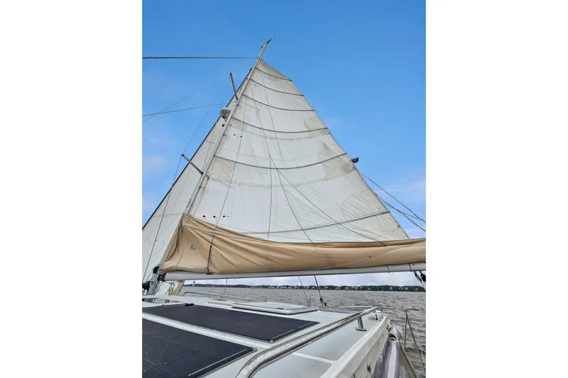 Surfer Girl Yacht Photos Pics Sailing on a 2018 Maine Cat 38 LS with full sails against a clear blue sky.