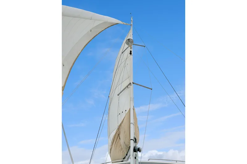 Surfer Girl Yacht Photos Pics Sails of a 2018 Maine Cat 38 LS against a clear blue sky.