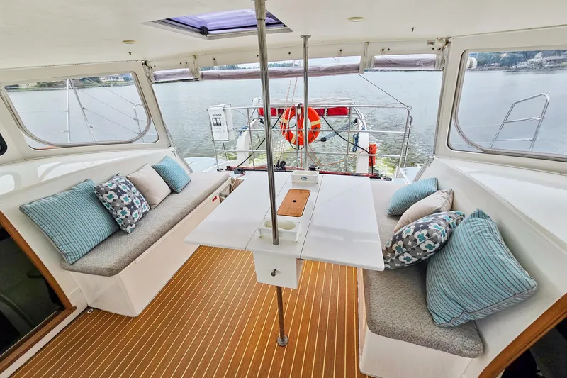 Surfer Girl Yacht Photos Pics Spacious interior of 2018 Maine Cat 38 LS with comfortable seating and scenic water view.