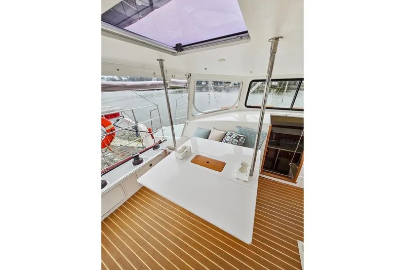 Surfer Girl Yacht Photos Pics 2018 Maine Cat 38 LS interior with seating, table, and scenic water view.