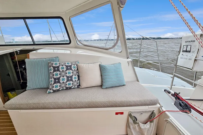 Surfer Girl Yacht Photos Pics 2018 Maine Cat 38 LS interior with cushioned seating and scenic water view.