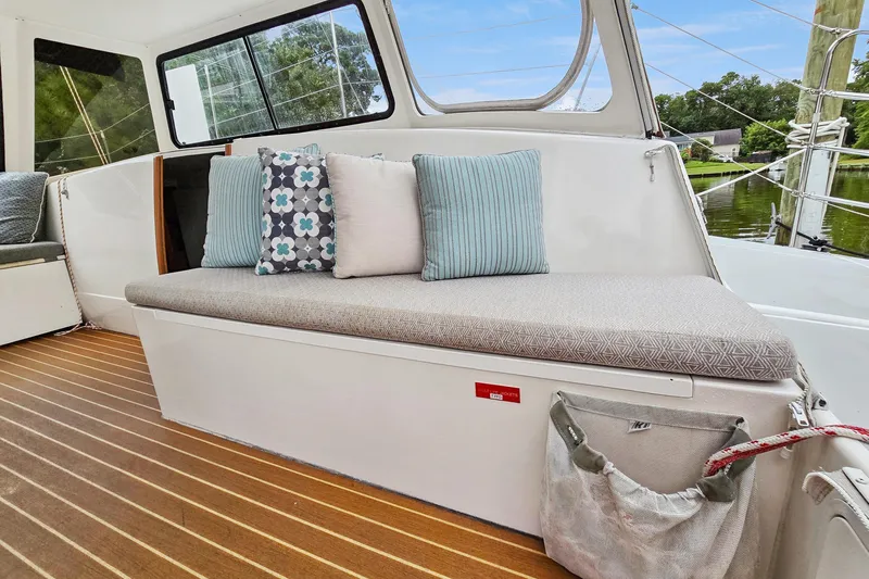 Surfer Girl Yacht Photos Pics 2018 Maine Cat 38 LS interior with cushioned seating and decorative pillows.