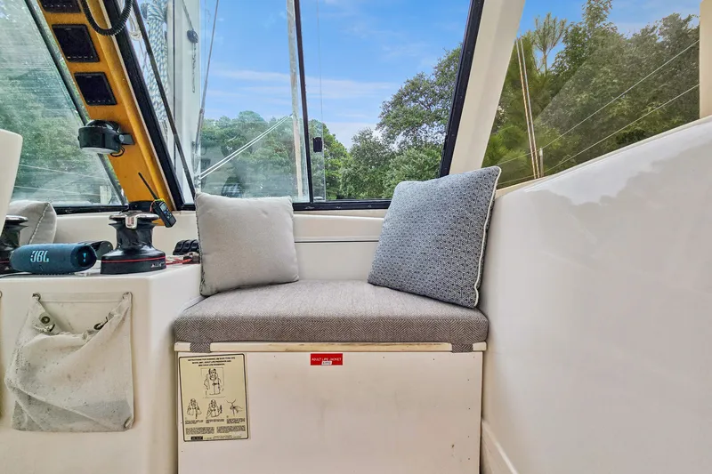 Surfer Girl Yacht Photos Pics Interior of 2018 Maine Cat 38 LS with cushioned seating and scenic window view.
