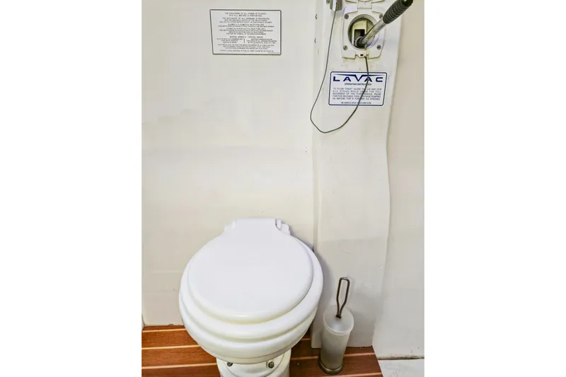 Surfer Girl Yacht Photos Pics Marine toilet in 2018 Maine Cat 38 LS, featuring Lavac system and wooden flooring.