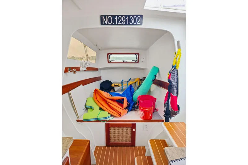 Surfer Girl Yacht Photos Pics Interior of 2018 Maine Cat 38 LS with colorful gear and wooden flooring.