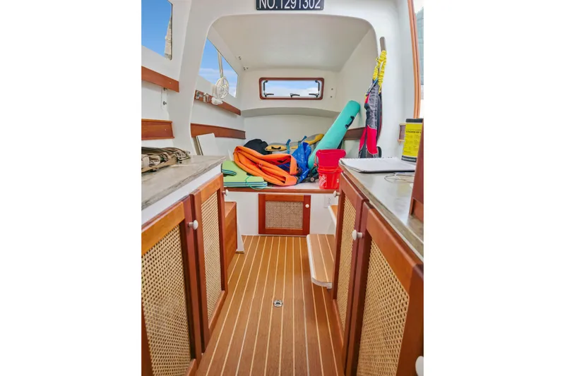 Surfer Girl Yacht Photos Pics Interior of 2018 Maine Cat 38 LS with wooden flooring and storage cabinets.