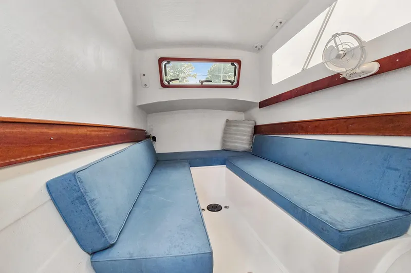 Surfer Girl Yacht Photos Pics Interior of 2018 Maine Cat 38 LS with blue seating and wooden accents.