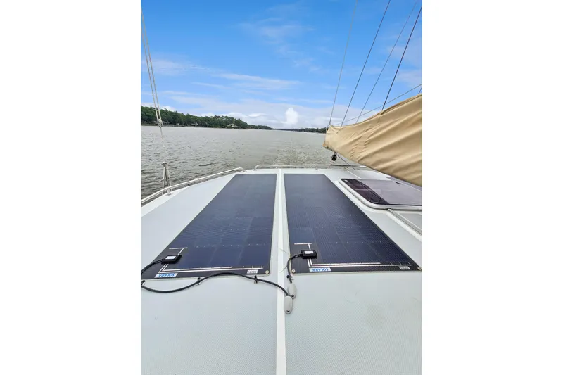 Surfer Girl Yacht Photos Pics 2018 Maine Cat 38 LS with solar panels on deck, sailing on a calm river.